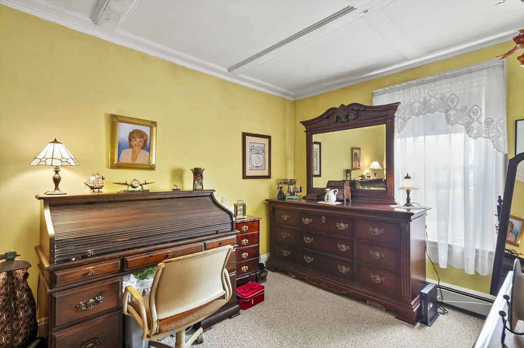 6 Prospect Street Merrimac, MA 01860 - Photo 13 of 40 a room with a bed and a mirror on the dresser