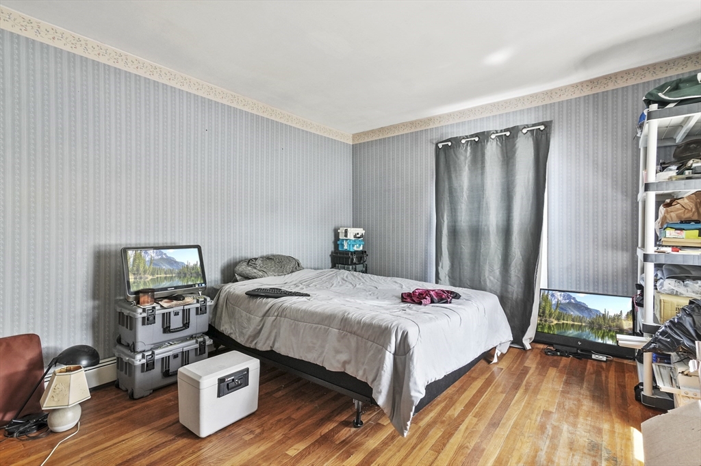 6 Prospect Street Merrimac, MA 01860 - Photo 20 of 40 a bedroom with a bed and wooden floor