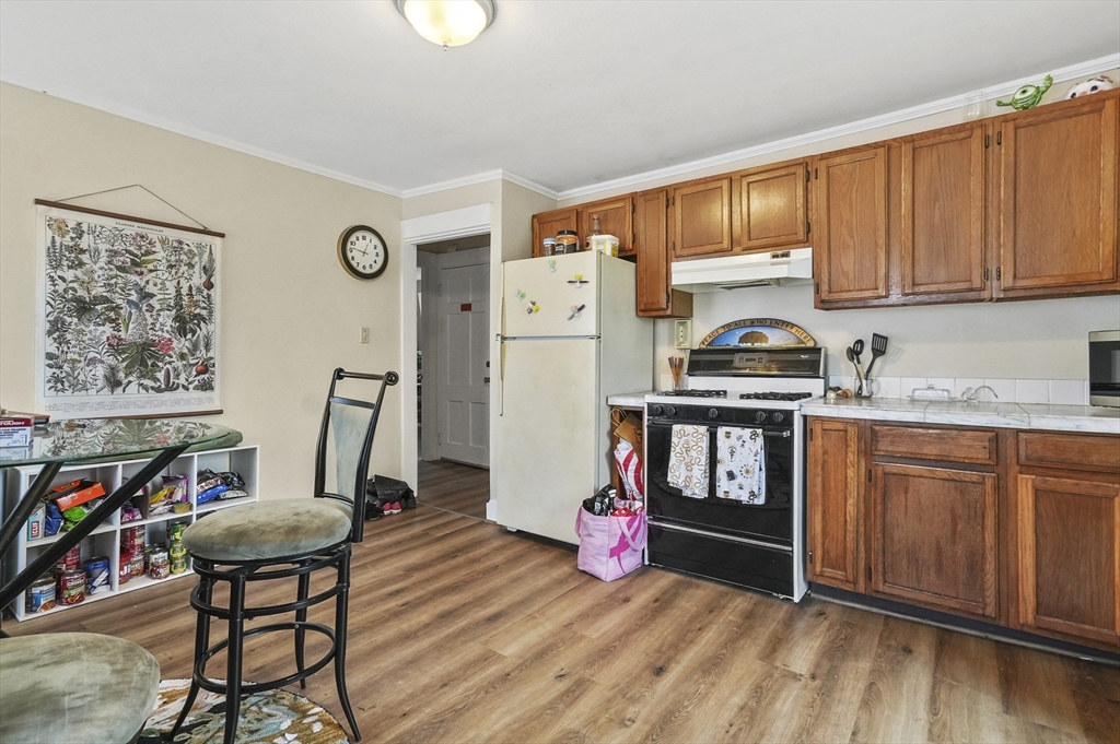 6 Prospect Street Merrimac, MA 01860 - Photo 29 of 40 a kitchen with stainless steel appliances granite countertop a refrigerator a stove top oven a sink dishwasher and white cabinets with wooden floor