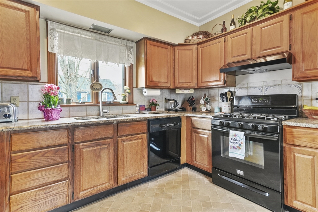 6 Prospect Street Merrimac, MA 01860 - Photo 3 of 40 a kitchen with stainless steel appliances granite countertop a sink a stove and cabinets