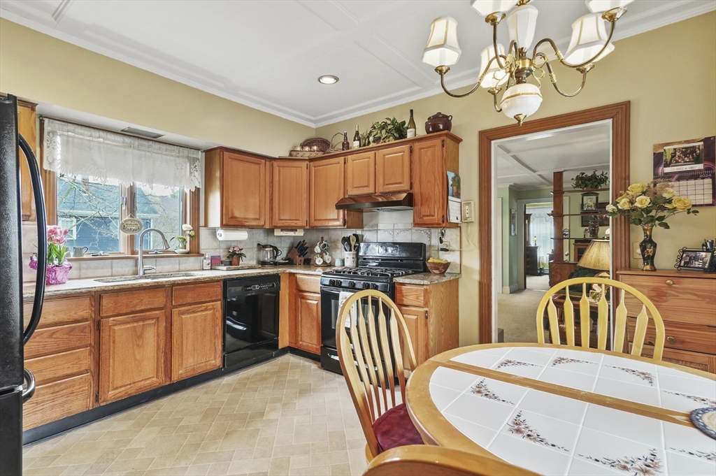 6 Prospect Street Merrimac, MA 01860 - Photo 4 of 40 a kitchen with stainless steel appliances kitchen island granite countertop a table and chairs in it