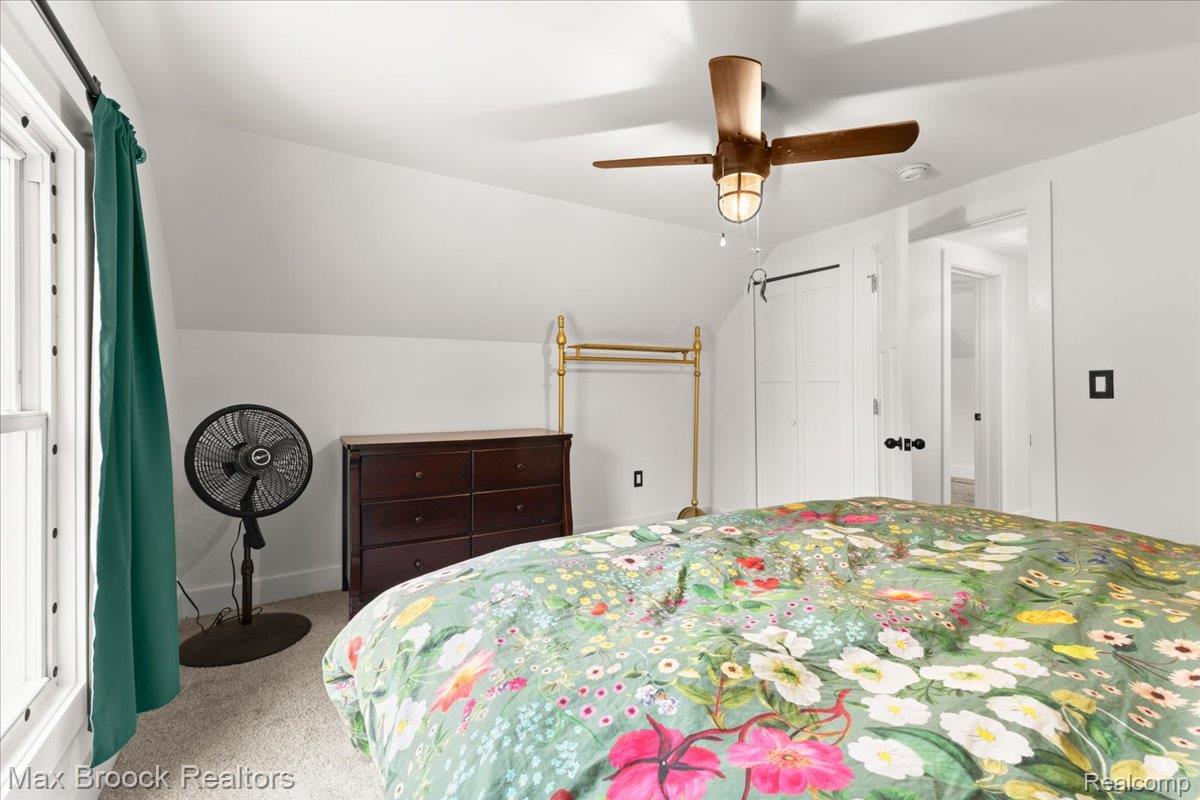 515 East Clinton Street Howell, MI 48843 - Photo 23 of 29 Carpeted bedroom featuring lofted ceiling, ceiling fan, and a closet