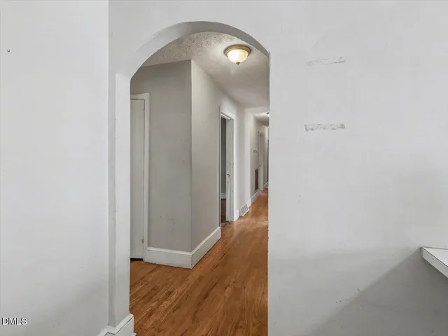 a view of a hallway with wooden floor