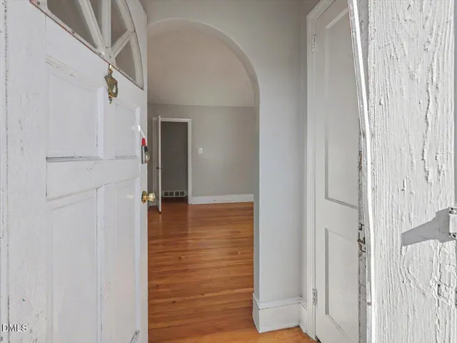 a view of hallway with stairs and wooden floor