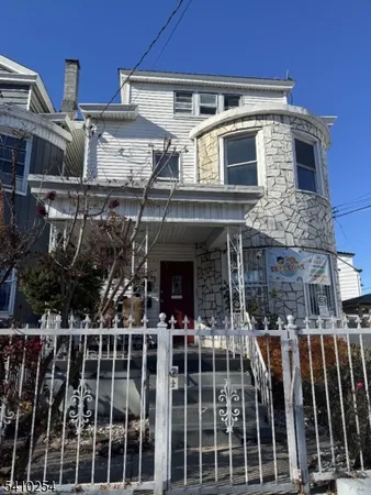 a front view of a building with parking