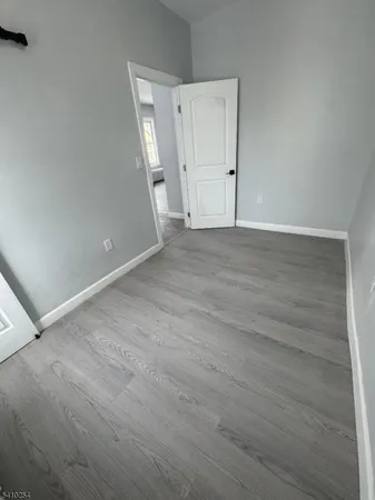 an empty room with wooden floor
