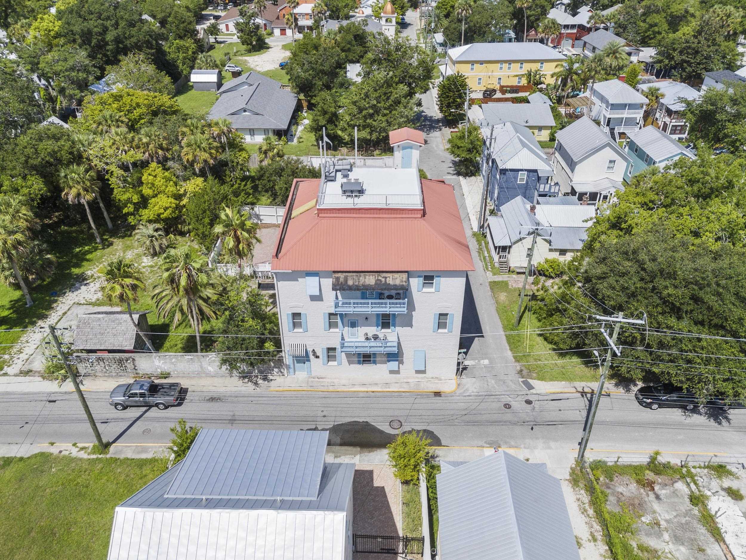 an aerial view of a house with garden space and street view