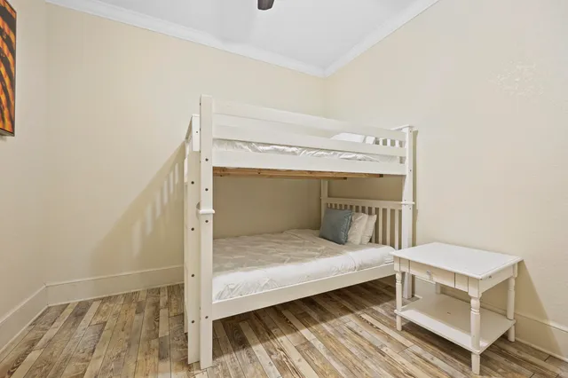 a living room with furniture kitchen view and a wooden floor