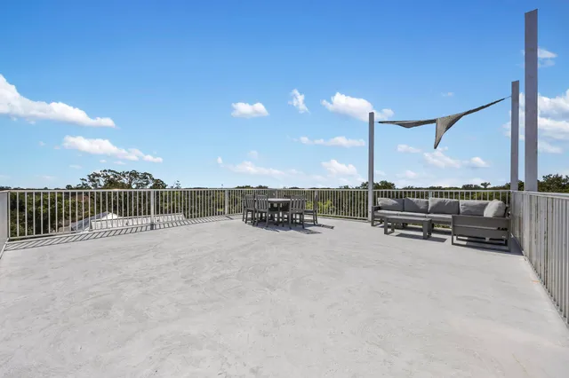 a bathroom with a granite countertop sink a toilet and a bathtub