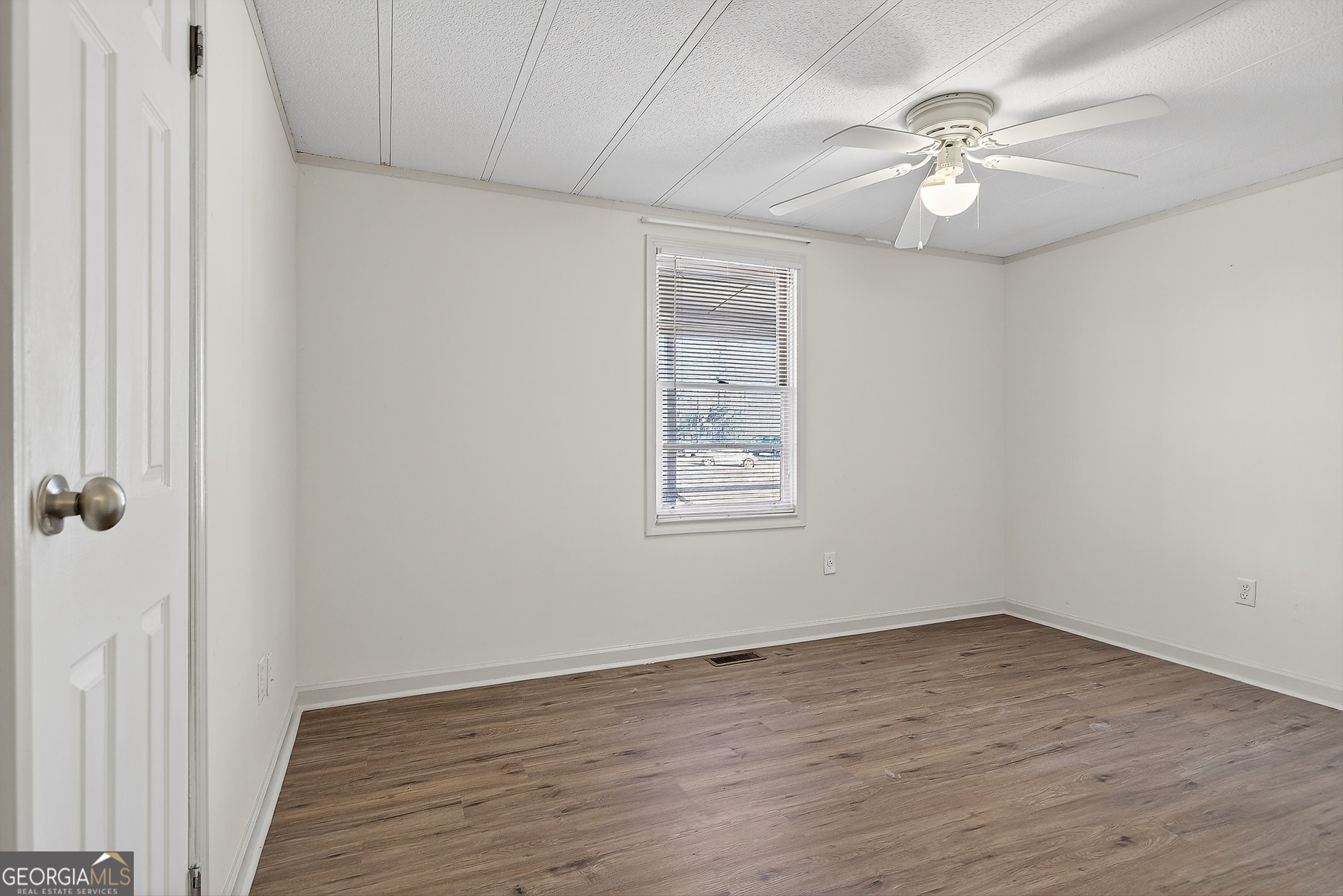 1470 Melville Brown Road Williamson, GA 30292 - Photo 11 of 36 wooden floor in an empty room with a window