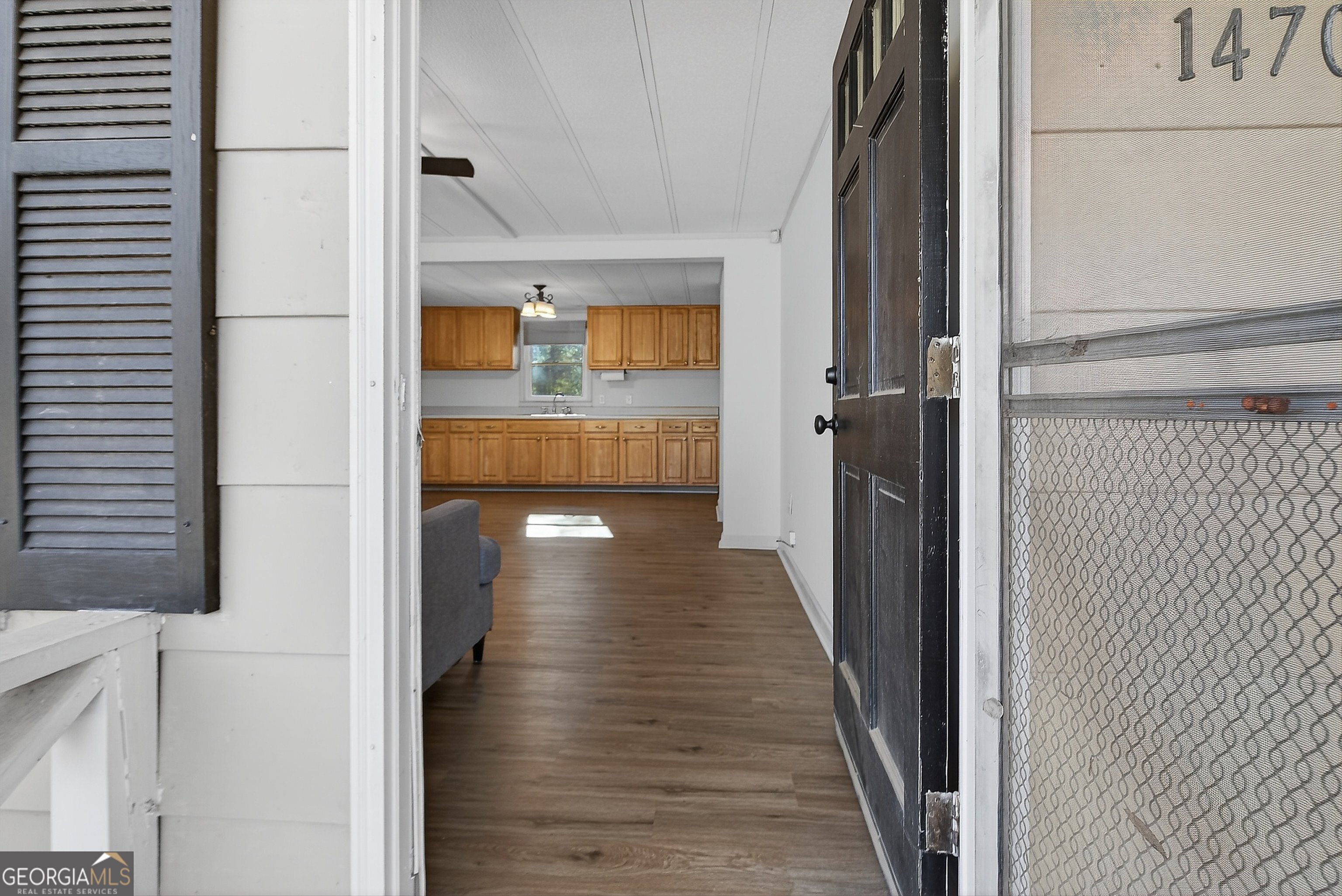 1470 Melville Brown Road Williamson, GA 30292 - Photo 4 of 36 a view of a hallway with wooden floor and staircase