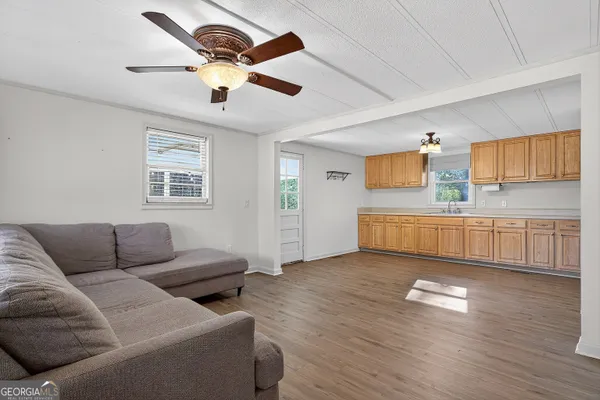 a living room with furniture and kitchen view