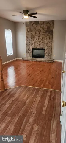 an empty room with fireplace and chandelier