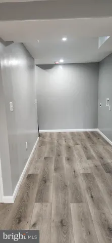 an empty room with wooden floor