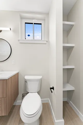 a white toilet sitting next to a bathroom sink