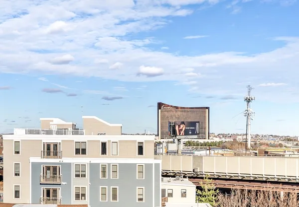 a front view of a lake with a multi story building