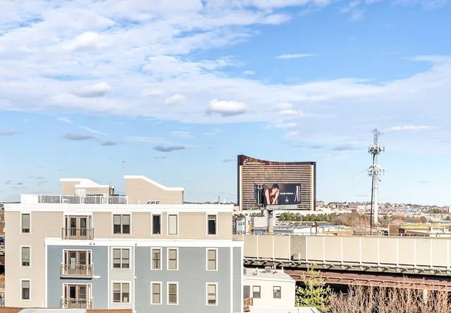 a front view of a lake with a multi story building