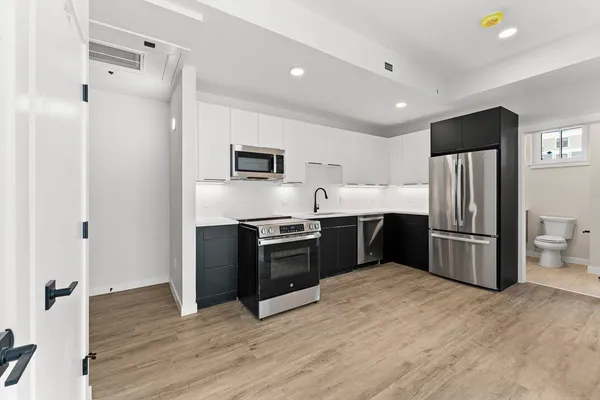 a kitchen with a refrigerator and a sink