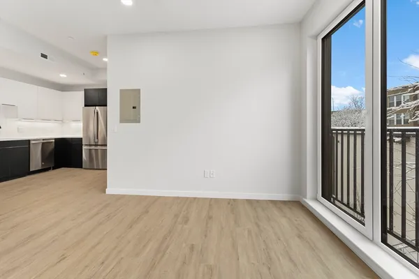 a view of a kitchen with wooden floor and staircase