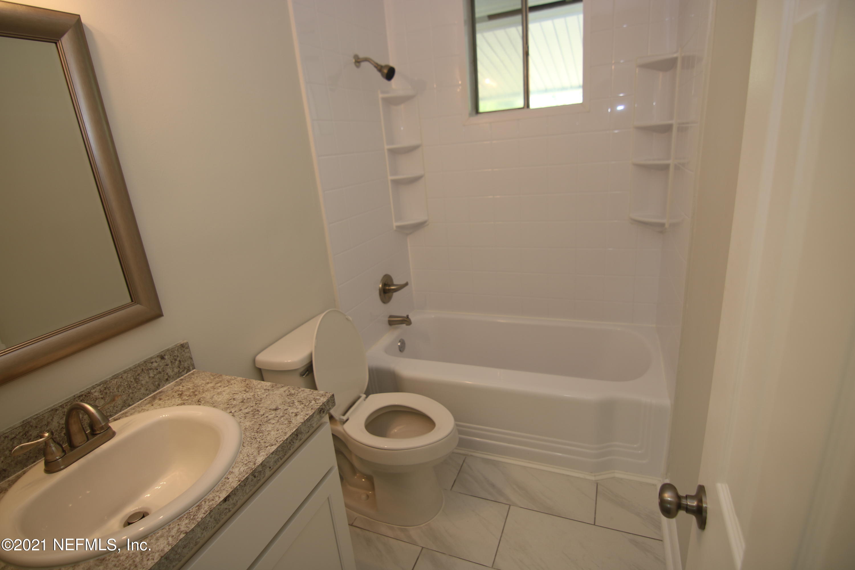 10624 Dodd Road Jacksonville, FL 32218 - Photo 17 of 21 a bathroom with a granite countertop sink a toilet and shower