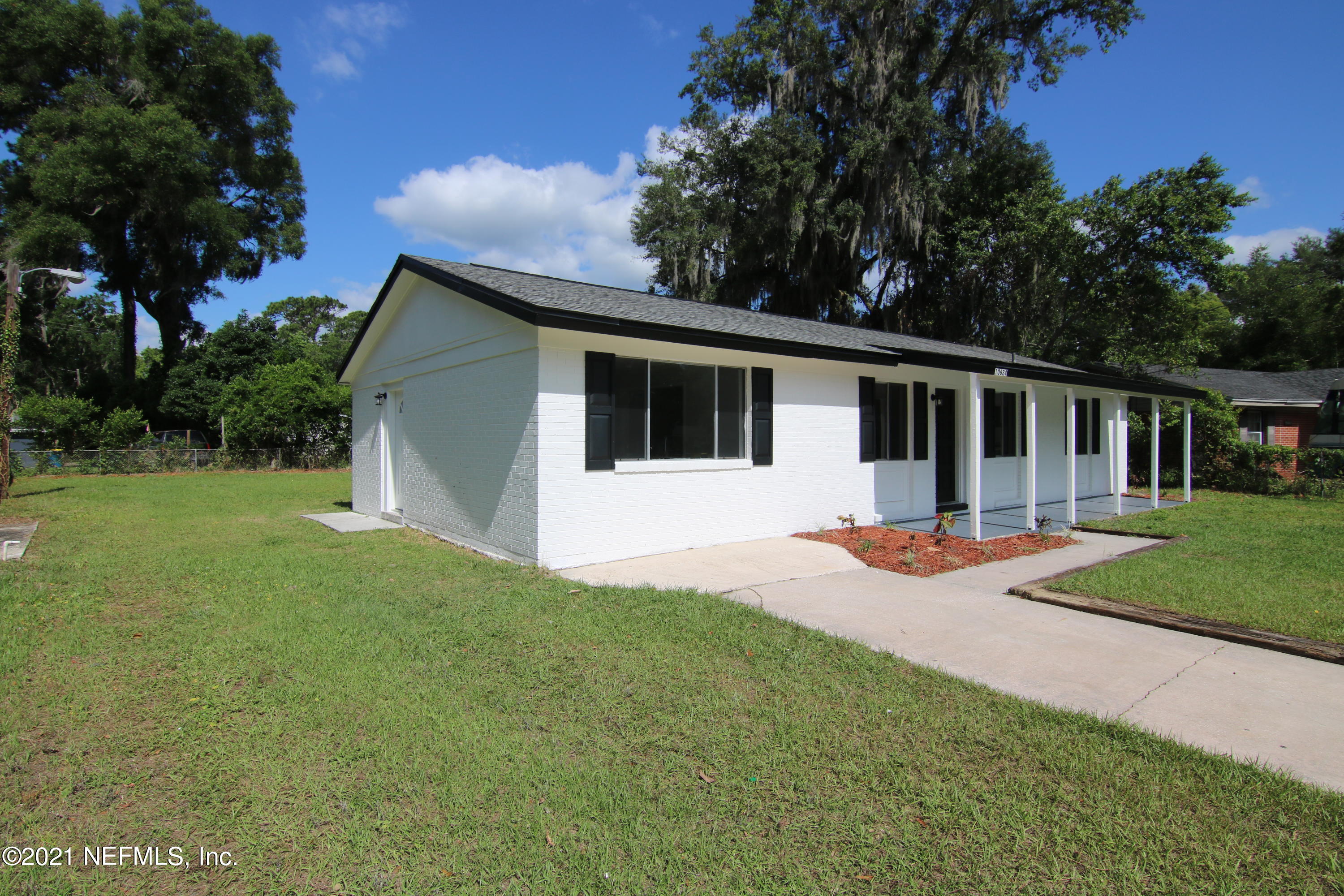 10624 Dodd Road Jacksonville, FL 32218 - Photo 3 of 21 a front view of a house with yard patio and green space