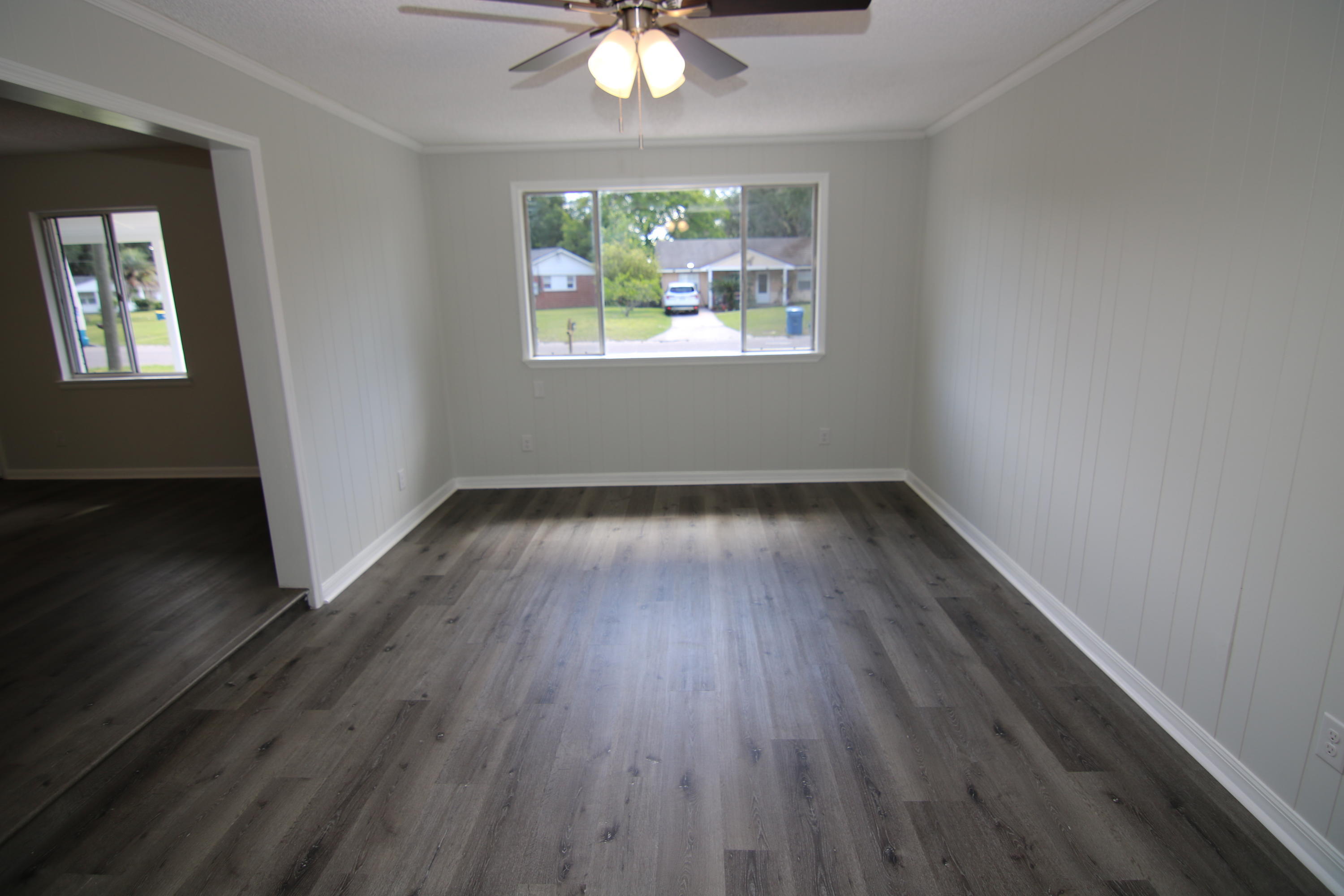 10624 Dodd Road Jacksonville, FL 32218 - Photo 6 of 21 a view of wooden floor in an empty room with a window