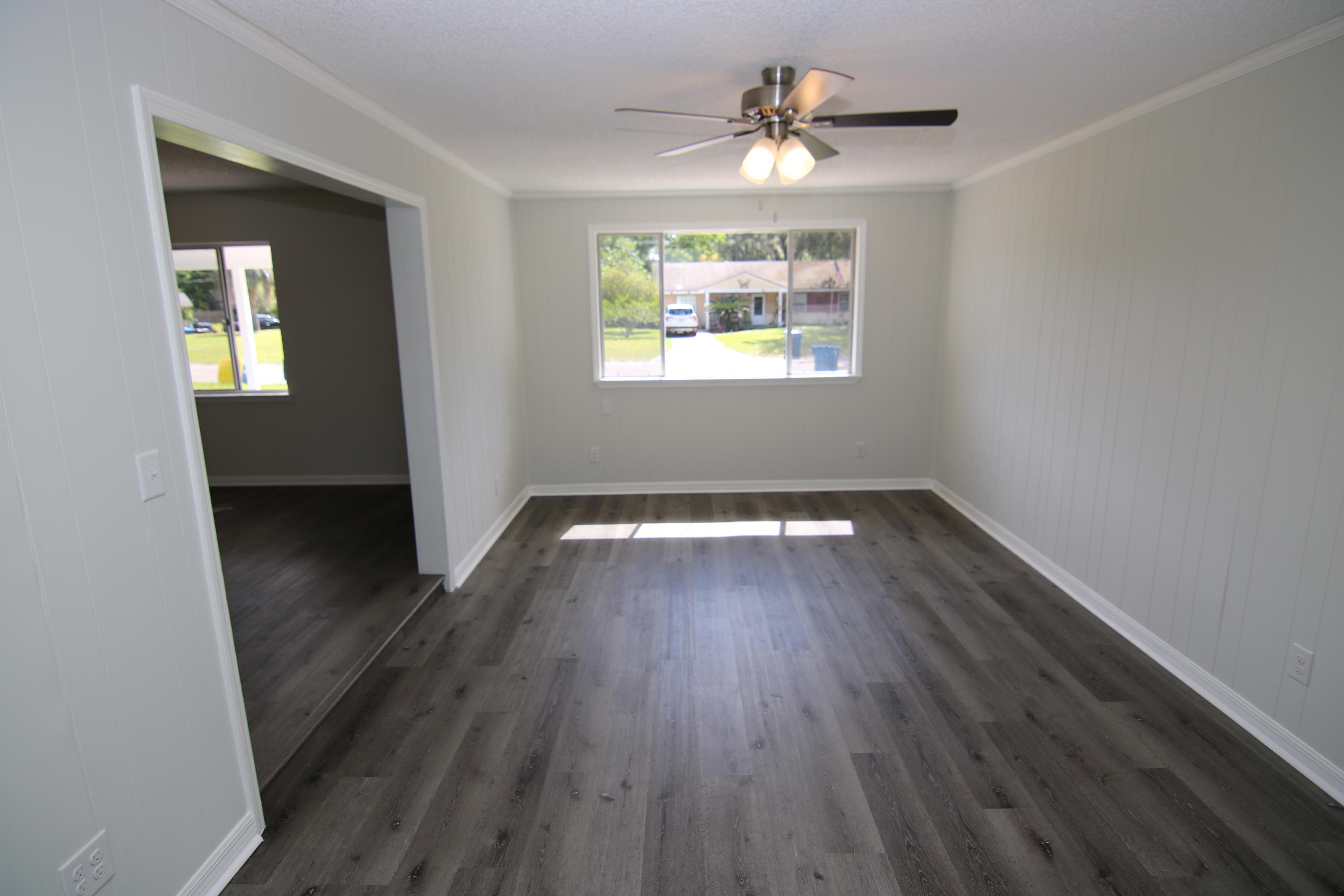10624 Dodd Road Jacksonville, FL 32218 - Photo 9 of 21 wooden floor in an empty room with a window
