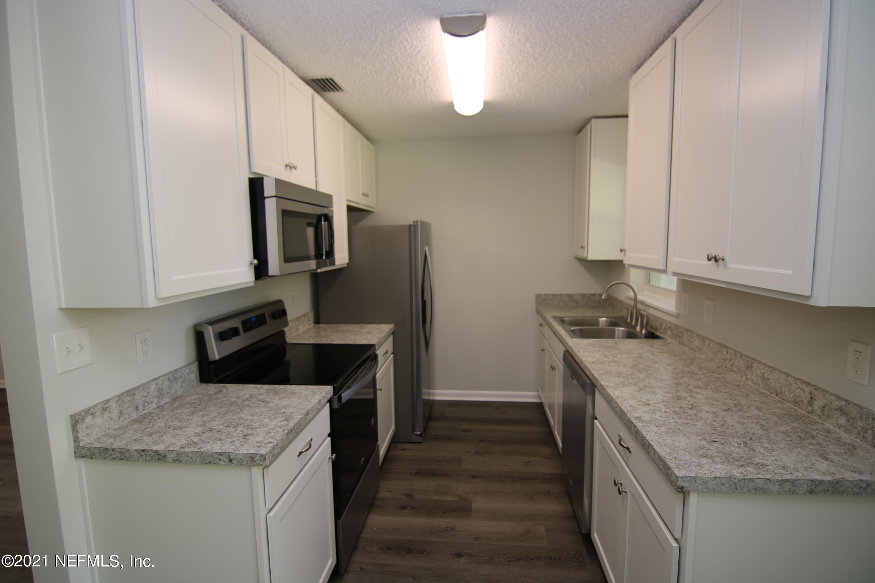 10624 Dodd Road Jacksonville, FL 32218 - Photo 10 of 21 a kitchen with a sink stove and refrigerator