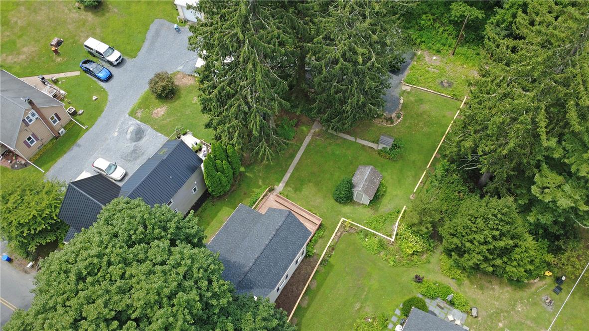 100 Creek Road Bangor, PA 18013 - Photo 15 of 51 An aerial perspective reveals a vast green yard, expansive driveway, and multiple dwellings nestled among mature trees.