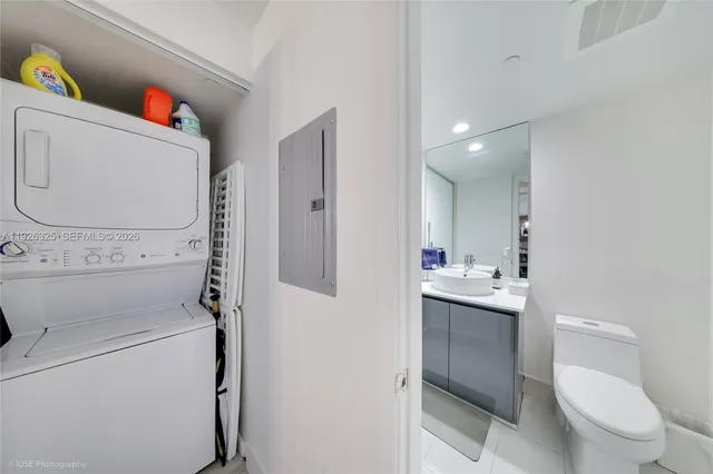 a bathroom with a sink toilet and a mirror