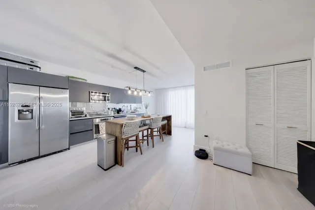 a living room with furniture a rug and a potted plant