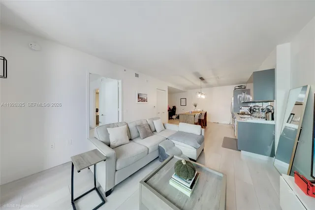 a bedroom with a bed and a lamp on dresser