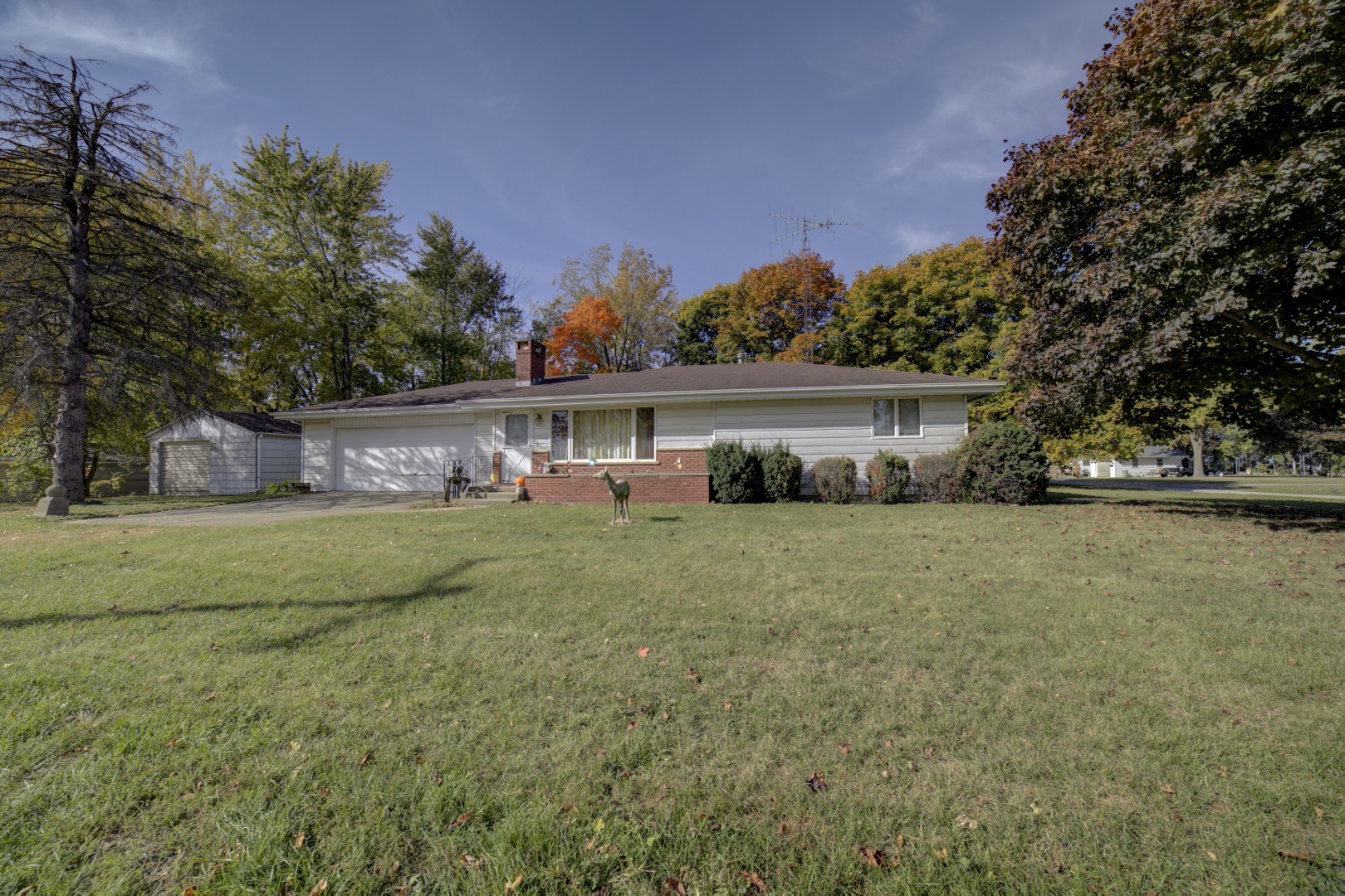 a front view of house with yard and trees