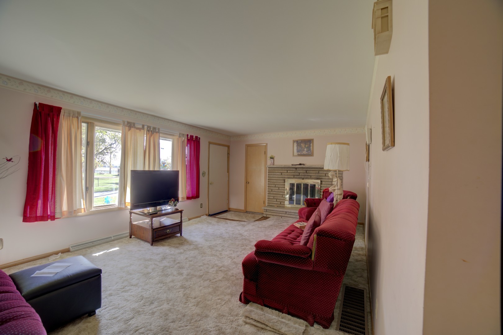 405 Deitrick Street Donovan, IL 60931 - Photo 13 of 29 a living room with furniture a flat screen tv and a window
