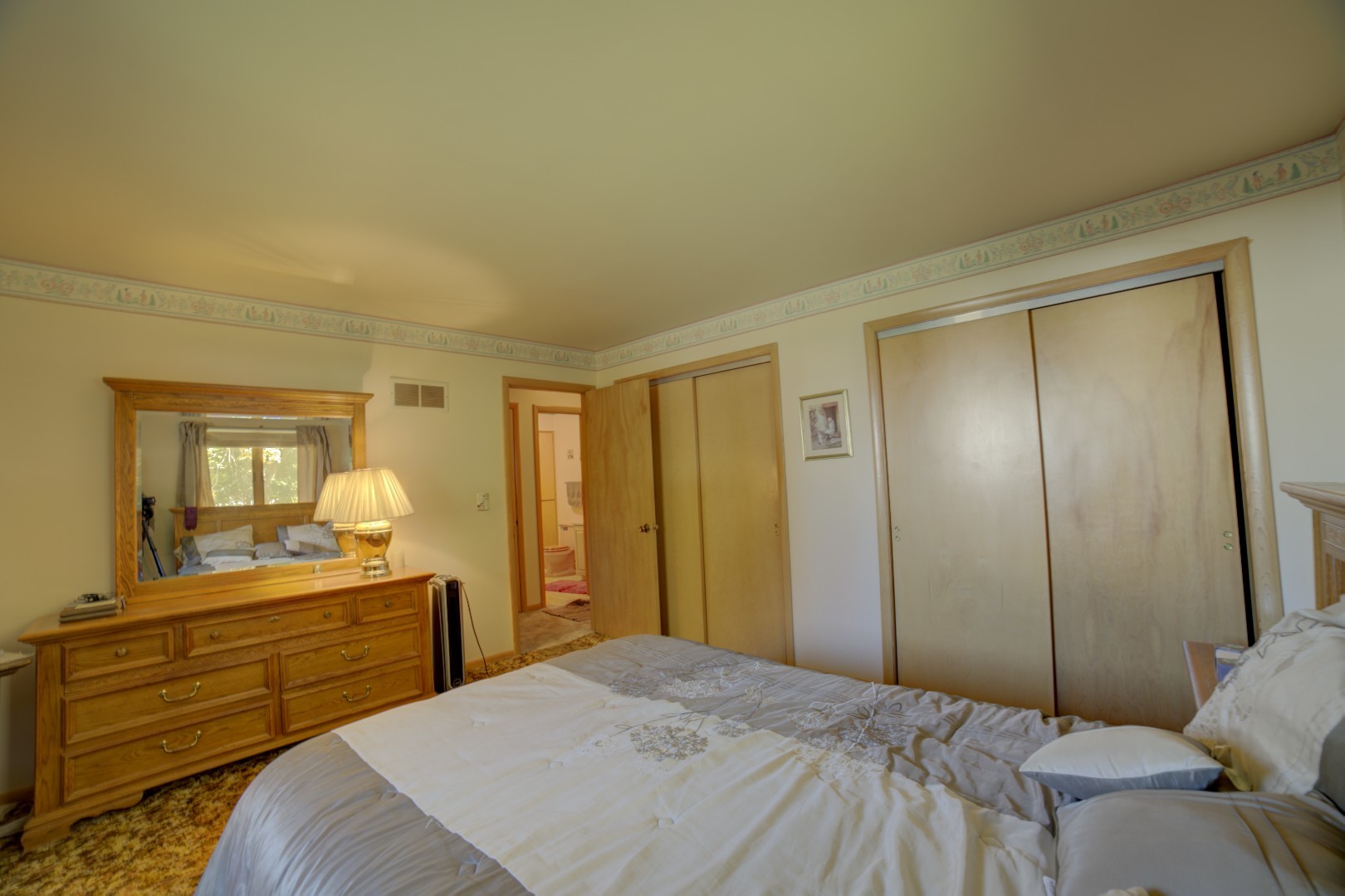 405 Deitrick Street Donovan, IL 60931 - Photo 22 of 29 a bedroom with a bed and a large mirror on dresser