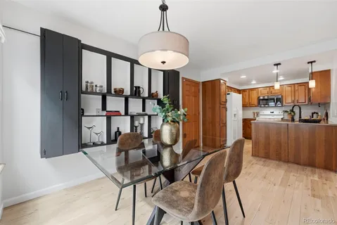 a kitchen with stainless steel appliances a stove a sink a refrigerator and cabinets