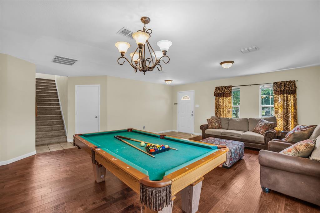 5718 Green Ivy Road Denton, TX 76210 - Photo 5 of 37 Spacious living area featuring wood-finish flooring, a decorative chandelier, and recessed lighting