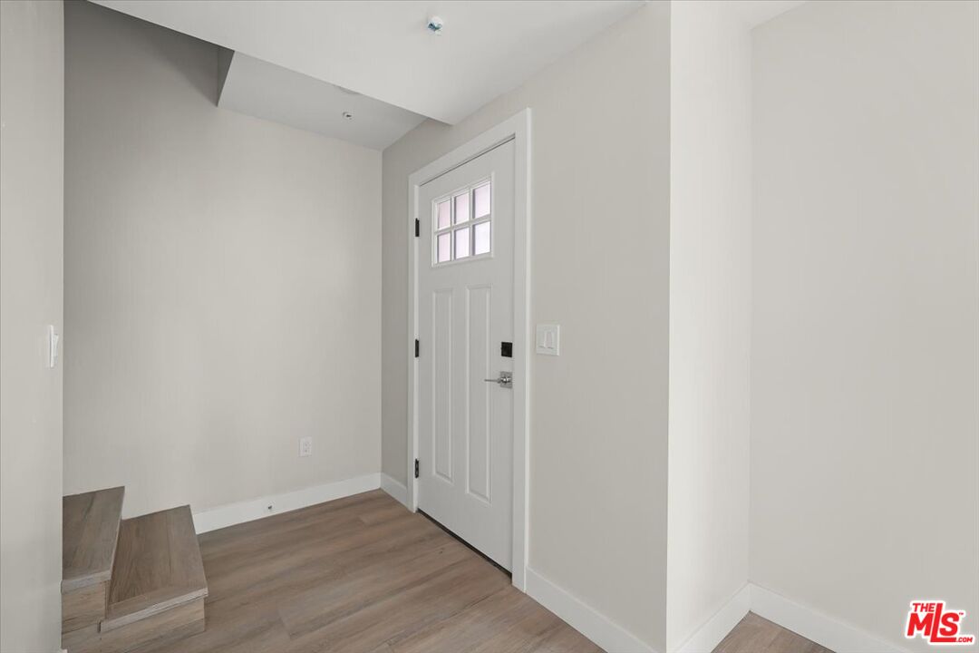 1317 Punta Gorda Street, Unit 12 Santa Barbara, CA 93103 - Photo 5 of 70 a view of an empty room with wooden floor and a window