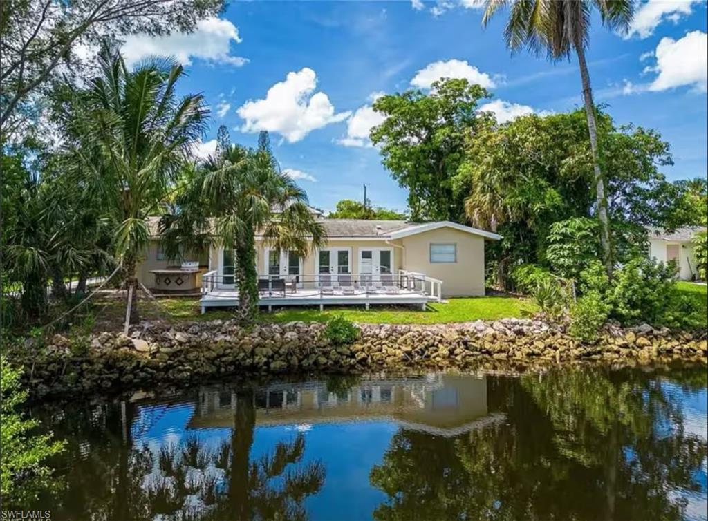 514 14th Street North Naples, FL 34102 - Photo 1 of 22 a front view of a house with a yard