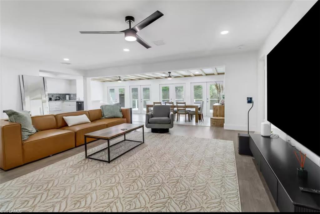 514 14th Street North Naples, FL 34102 - Photo 3 of 22 a living room with furniture and a flat screen tv