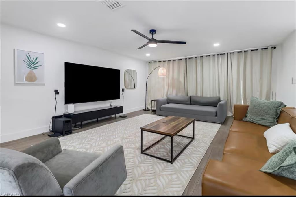514 14th Street North Naples, FL 34102 - Photo 4 of 22 a living room with furniture and a flat screen tv