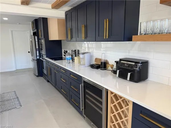 a kitchen with stainless steel appliances granite countertop a sink stove and microwave