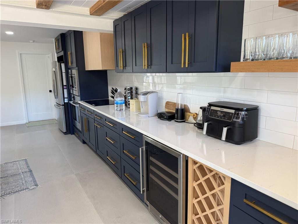514 14th Street North Naples, FL 34102 - Photo 6 of 22 a kitchen with stainless steel appliances granite countertop a sink stove and microwave