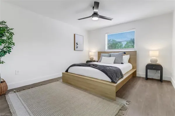 a bedroom with a bed and a lamp