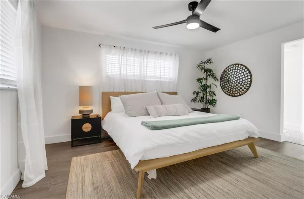514 14th Street North Naples, FL 34102 - Photo 10 of 22 a bedroom with a bed and a chandelier