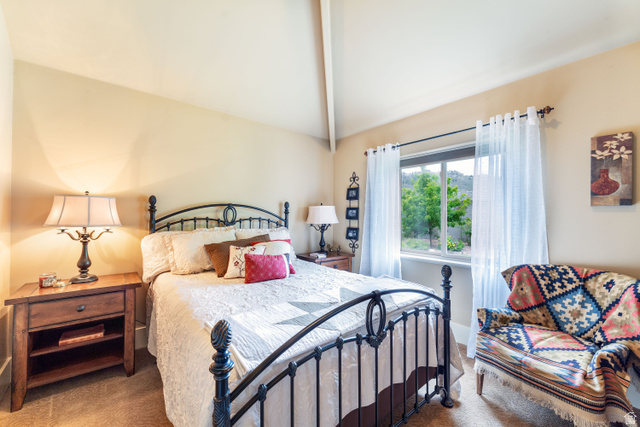 7343 North Sawtooth Cv Road Vernal, UT 84078 - Photo 25 of 64 Vaulted ceiling bedroom with a prominent window, and carpet flooring