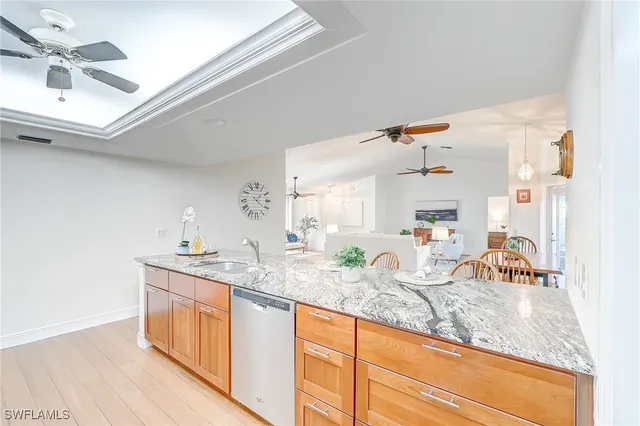 a kitchen with granite countertop a sink a stove cabinets and counter space