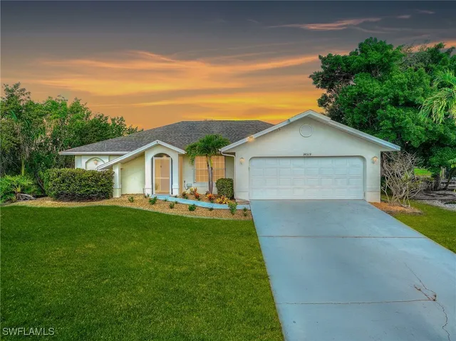 a front view of house with yard patio and green space