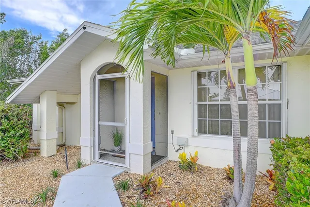 a front view of a house with outdoor seating and trees