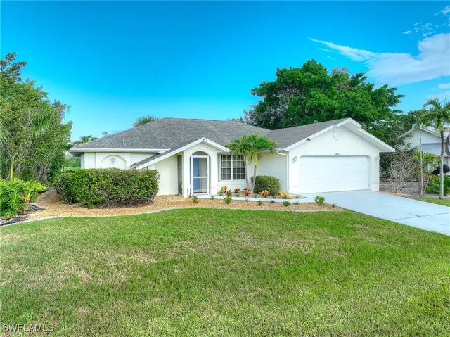 a front view of house with yard and outdoor seating